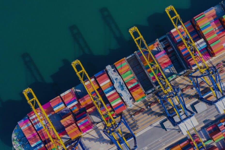 Container ship docked in port under cranes